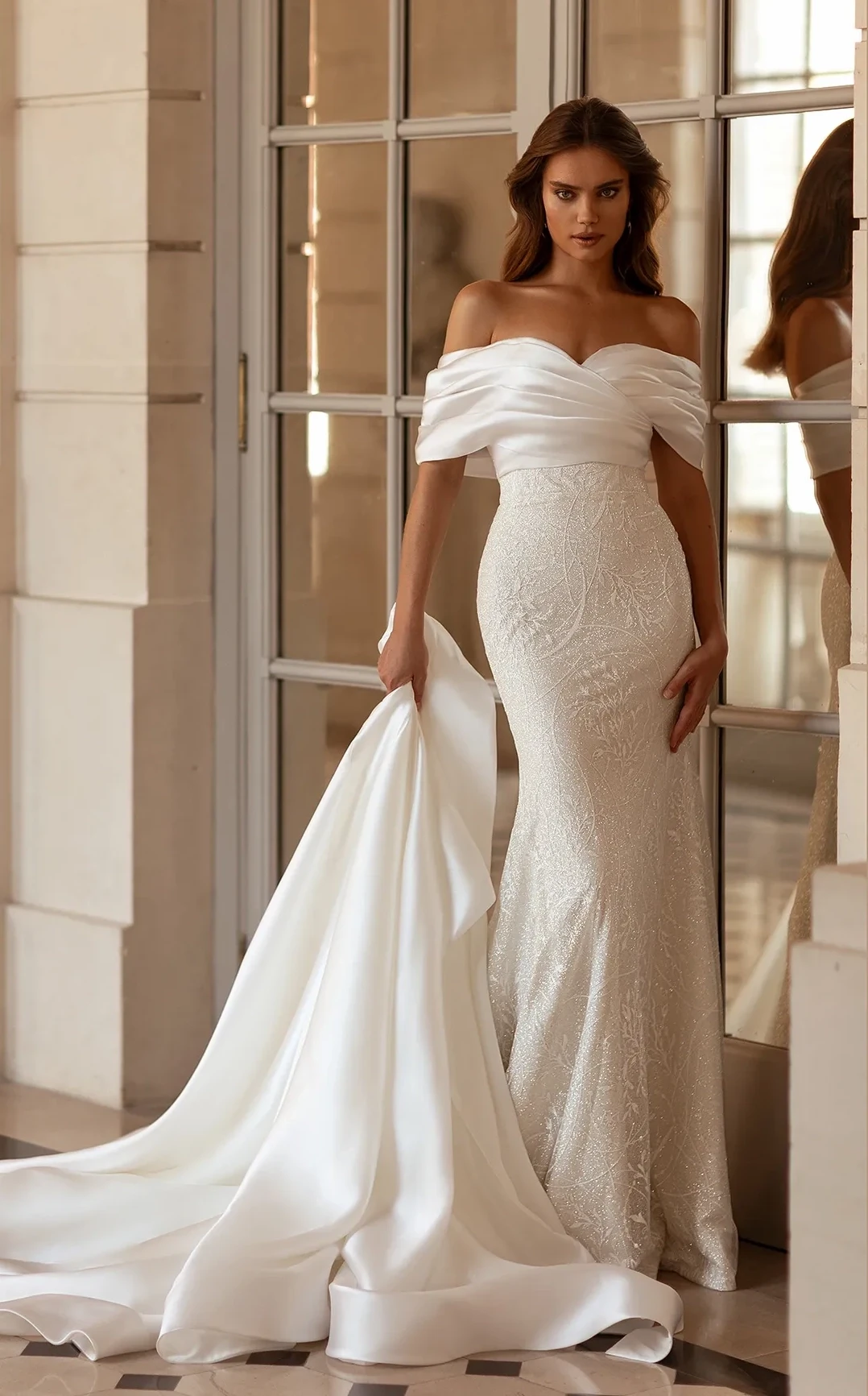 Model wearing a white Oliver Martino gown