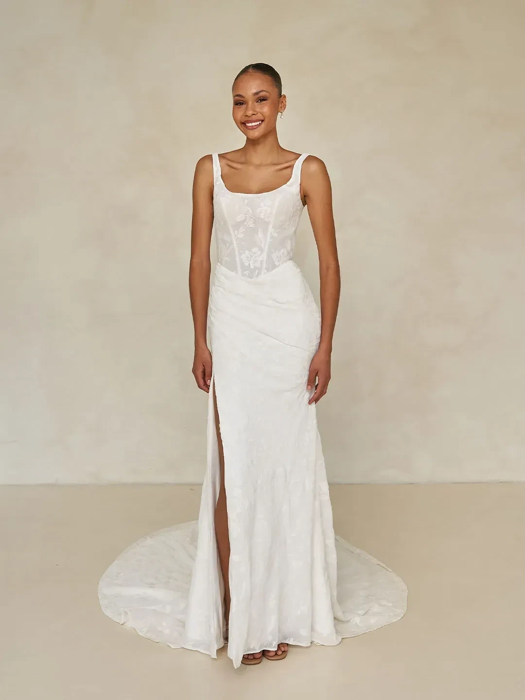 Model wearing a white Madi Lane gown